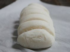 a long loaf of bread sitting on top of a piece of paper