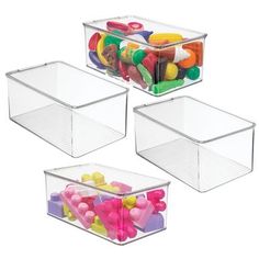 three clear storage bins filled with candy