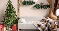 a living room decorated for christmas with presents on the floor and trees in the corner