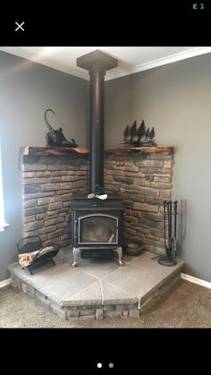 a wood burning stove sitting inside of a living room next to a firewood log