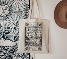 a tote bag sitting on top of a table next to a hat