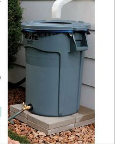 a blue trash can sitting in front of a house