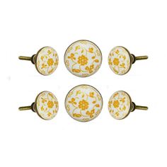 four yellow and white knobs with flowers on them