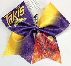 a close up of a purple and yellow bow on a white background with text that reads taki's