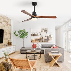 a living room filled with furniture and a flat screen tv mounted to the side of a wall