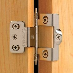 a close up view of a wooden door with metal hinges