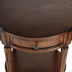 a round wooden table with two drawers on one side and an oval drawer on the other