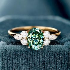 Teal color Moissanite Ring, 14k Solid Gold Ring, Moissanite Ring, Engagement Ring, Gift For Her, Natural Moissanite Promise Ring for Women  (in stock) - Metal: 14K Yellow Gold - Custom Color: Rose Gold, Yellow Gold, and White Gold  - Gross weight: 2.33g - Gold Weight: 2.02g - Gemstones: Moissanite - Moissanite CTW: 1.18ct (1pcs) - Moissanite size: 6mm*8mm - Moissanite CTW: 0.380 (6pcs) - Ring size: 7 - Ring Width: 20.17mm Approximately - Ring Height: 24.09mm Approximate Shipping It usually takes 2-3 weeks to make and 3-5 days to ship We apply a tracking number for every single package. Engraving You can order a custom engraving. (just contact me in advance) 7 Ring, Solid Gold Ring, Ring Moissanite, Teal Color, Ring Engagement, Moissanite Ring, Moissanite Rings, Teal Colors, Ring For Women