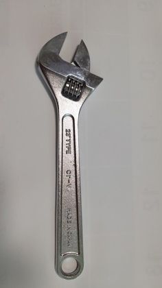 a wrench with an open end on a white surface