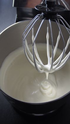 a whisk is being stirred in a bowl