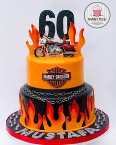 a motorcycle themed birthday cake with flames on the top and number 60 on the bottom