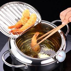 a person is cooking shrimp in a pot on the stove