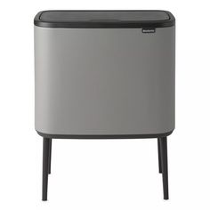 an image of a small trash can with black legs and grey plastic cover on top