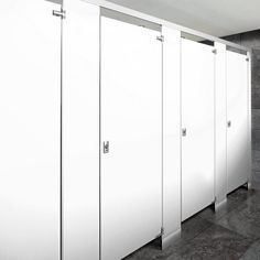 a row of white stalls sitting next to each other