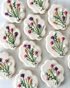 twelve decorated cookies with flowers on them