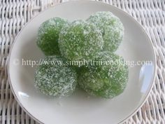 green powdered sugar balls on a white plate