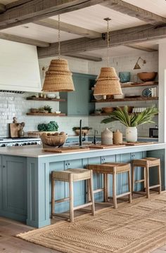 an open kitchen with blue cabinets and wicker baskets hanging from the ceiling over the island