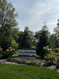 the sign for porthole woods is surrounded by flowers and trees