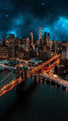 an aerial view of a city at night with the lights of cars and bridges lit up