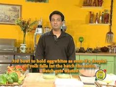 a man standing in front of a kitchen counter with food on top of it and an advertisement above him