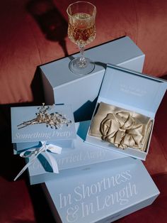 three boxed items including a glass of wine and an ornament in a box