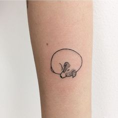 a small black and white cat tattoo on the right arm, with a tiny mouse in it's mouth