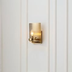 a light that is on the side of a white door with a handle and two lights