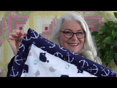 a woman holding up two pillows in front of her face with the words self binding blanket on it