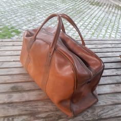 Vintage luggage 1950s -60s. It is in perfect condition. Zipper functioned. Wooden base inside.    Charcteristic tan color. Rare.Ready to use. Measurements; Width: 15 cm  (  5.91  inch ) Height: 28 cm ( 11.02  inch ) Length: 47 cm  ( 18.5 inch ) Paypal is the SOLO payment method at HUNTECLECTIC,  If you prefer to checkout with CREDIT CARD,just let us know so we can direct your order to our other shop where ETSY PAYMENTS İS AVAILABLE! All orders will be shipped within 1-3 business days . Estimated arrival time for EU is app. 3-7 days Estimated arrival time for USA,is app. 15-25 business days depending on the state. If you prefer express shipping please let us know,so we can offer a new shipping fee for you. Thanks for your kind interest! Vintage Brown Luggage For Everyday Use, Vintage Leather Travel Bag For Business Trips, Vintage Brown Travel Bag, Vintage Brown Luggage For Trips, Vintage Cognac Travel Bag, Vintage Leather Travel Bag For Formal Use, Vintage Brown Briefcase For Everyday, Vintage Brown Rectangular Luggage, Vintage Rectangular Business Travel Bag