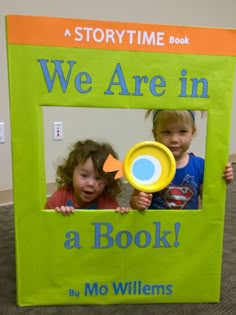 two children holding up a book with the title we are in a book