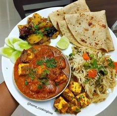 a white plate topped with different types of food on top of a table next to a person's hand