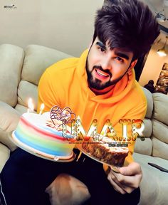 a man sitting on a couch holding a cake