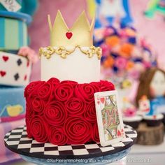 a red and white cake with a gold crown on top