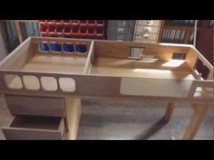 a wooden desk with drawers and shelves on it