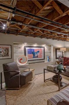 a living room with couches, chairs and pictures on the wall in it's center