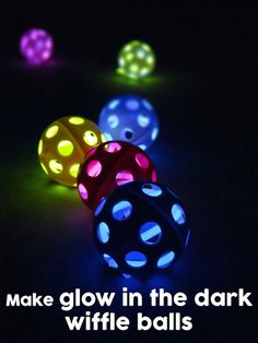 four glowing dices in the dark with different colors