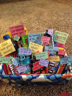 a basket filled with lots of candy on top of a carpet