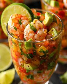 shrimp salad in a glass with limes and cilantro garnishes