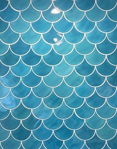 a blue and white tile with fish scales on it