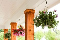 three hanging flower baskets on the front porch