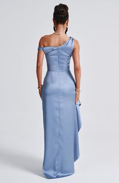 a woman in a blue dress looking back