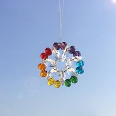 a multicolored wind chime hanging in the sky