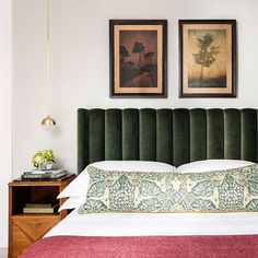 an instagramted photo of a bed with green velvet headboard and foot board