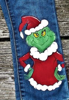 a pair of jeans with an image of the grino on it and santa's hat