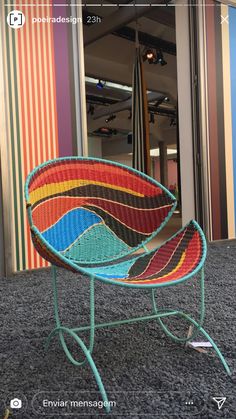 a colorful chair sitting on top of a carpet covered floor