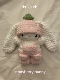 a crocheted stuffed animal wearing a pink outfit