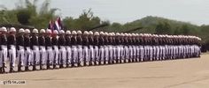 a long line of men in white uniforms