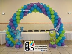 the balloon arch is decorated with blue, green and purple balloons that are shaped like monsters