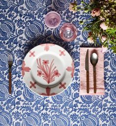 an overhead view of a plate, utensils and napkins on a table