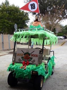 a golf cart decorated with green grass and decorations